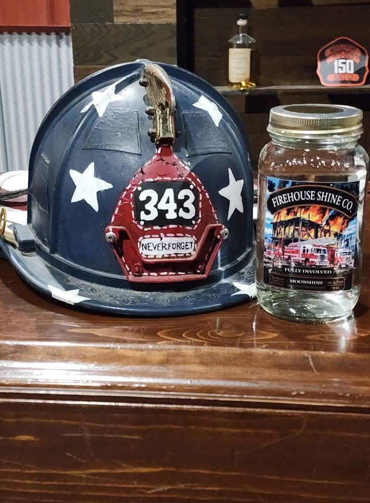 Fully Involved Moonshine beside a firefighter helmet honoring the 343